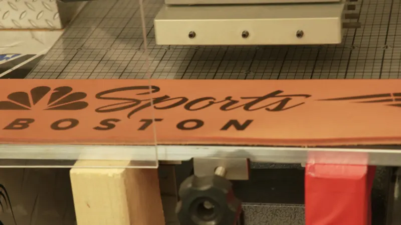 A Cardillo weight belt laser tattooed with the NBC Sports Boston logo, still in the laser bed