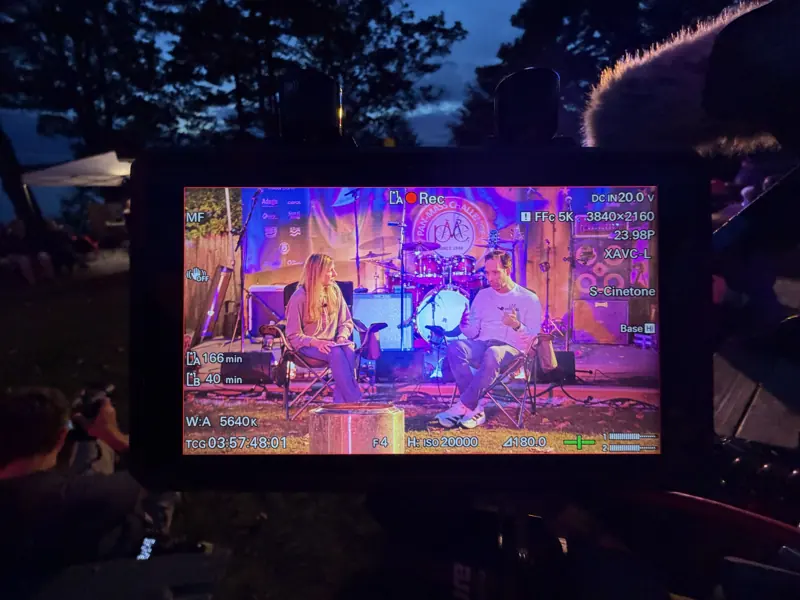 A camera monitor recording the two-shot of Meredith Beaton-Starr and Dr. Ben Ebert on stage