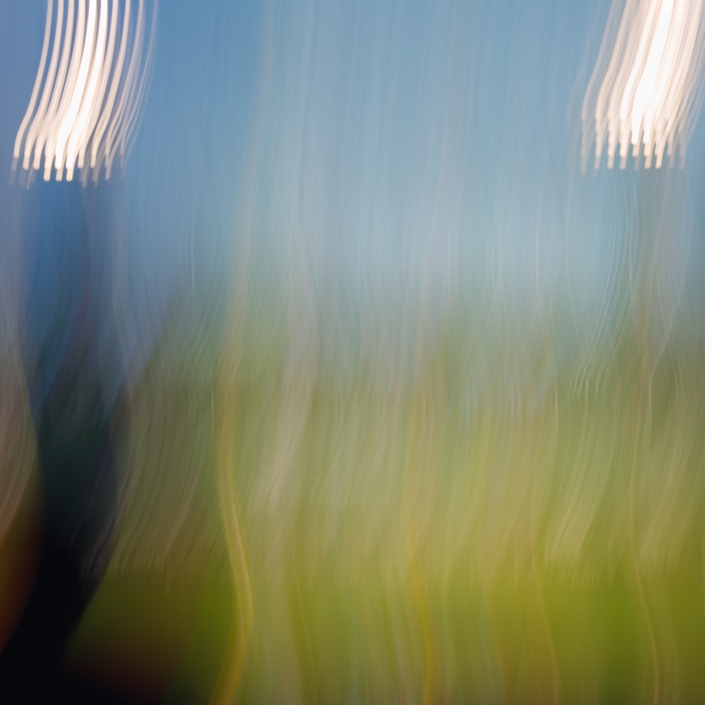 Under the Lights of Fenway Park: light towers over green grass and blue sky, Boston, abstract intentional camera movement photograph